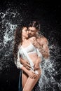 portrait of sexy young couple with water splash