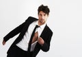 He has that effect on ladies. Portrait of a sexy young man pulling open his unbuttoned shirt wearing a smart balck suit