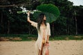 Portrait young woman in bikini and tunic with large leaf tropical tree Royalty Free Stock Photo