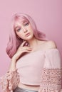 Portrait of a sexy young woman with pink hair. Perfect hairstyle and hair coloring. Girl with beautiful blue eyes and long pink Royalty Free Stock Photo