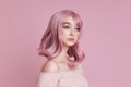 Portrait of a sexy young woman with pink hair. Perfect hairstyle and hair coloring. Girl with beautiful blue eyes and long pink Royalty Free Stock Photo