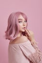 Portrait of a sexy young woman with pink hair. Perfect hairstyle and hair coloring. Girl with beautiful blue eyes and long pink Royalty Free Stock Photo