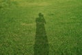 Portrait shadow and silhouette of photographer on the grass field. Royalty Free Stock Photo
