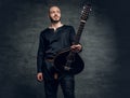 Portrait of musician dressed in old Celtic clothes holds vintage mandolin.