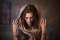 Portrait in the shawl. Tribal dancer, beautiful woman in the ethnic style on a textured background Royalty Free Stock Photo