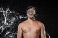 portrait of shirtless man in swimming mask with snorkel swilled with water