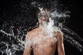 portrait of shirtless man in swimming mask with snorkel swilled with water splash