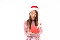 Portrait of a shocked asian girl in christmas hat Royalty Free Stock Photo