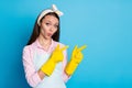 Portrait of shocked astonished girl cleaner pint index finger copyspace rubber gloves demonstrate incredible ads Royalty Free Stock Photo