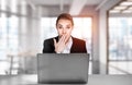 Portrait of shocked attractive business woman in suit sitting at Royalty Free Stock Photo