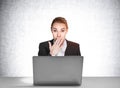 Portrait of shocked attractive business woman in suit sitting at the desk in front of laptop and dreaming about career Royalty Free Stock Photo