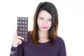 Portrait of a shocked brown haired woman with bar chocolate in hand Royalty Free Stock Photo