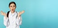 Portrait of shocked female doctor, worried healtcare worker in white robe, looking concerned at patient, standing over