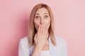 Portrait of shocked girl share secret cover close lips hand palm over pink color background