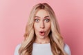 Portrait of shocked gorgeous girl open mouth staring camera on pink background