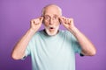 Portrait of shocked grey hair beard pensioner touching specs healthy vision isolated over purple color background