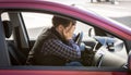 Portrait of shocked male driver closing face with hands