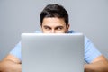 Portrait of shocked man sitting at the table with laptop Royalty Free Stock Photo