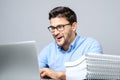 Portrait of shocked man sitting at the table with laptop Royalty Free Stock Photo