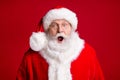 Portrait of shocked santa claus x-mas tradition discounts wear red costume isolated over bright vivid color background Royalty Free Stock Photo