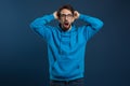 Portrait of shocked scared young man grabbing head and looking at camera Royalty Free Stock Photo