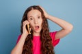 Portrait of shocked speechless small lady hold cell phone open mouth make call on blue background Royalty Free Stock Photo