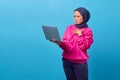 Portrait of shocked surprised girl standing and holding laptop computer Royalty Free Stock Photo