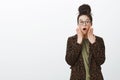 Portrait of shocked surprised girlfriend in leopard coat and black trendy glasses, dropping jaw, saying wow and holding Royalty Free Stock Photo