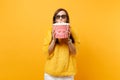 Portrait of shocked young girl in 3d imax glasses watching movie film, covering mouth with bucket of popcorn isolated on