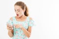 Portrait shocked young girl in dress looking at mobile phone isolated on white background