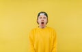 Portrait of shocked young man in casual clothes and cap standing on yellow background with emotional face looking at camera Royalty Free Stock Photo