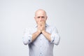 Portrait of a shocked young man covering his mouth with hands Royalty Free Stock Photo