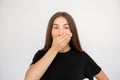 Portrait of shocked young woman covering mouth with hand Royalty Free Stock Photo