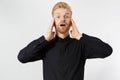 Portrait of shoked red-hair male groom realizes that he forgot to buy rings, dressed in black shirt with white bowtie, stares at