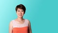 Portrait of short haired Asian woman smiling On a Green blue background