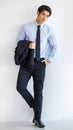 Portrait shot of Asian young charming success smart businessman model take black formal suit jacket uniform off hold on arm Royalty Free Stock Photo