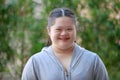 Portrait shot of Asian young chubby down syndrome autistic autism little cute schoolgirl with braid pigtail hairstyle model stand Royalty Free Stock Photo