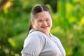 Portrait shot of Asian young chubby down syndrome autistic autism little cute schoolgirl with braid pigtail hairstyle model stand Royalty Free Stock Photo