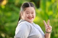 Portrait shot of Asian young chubby down syndrome autistic autism little cute schoolgirl with braid pigtail hairstyle model stand Royalty Free Stock Photo