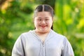 Portrait shot of Asian young chubby down syndrome autistic autism little cute schoolgirl with braid pigtail hairstyle model stand Royalty Free Stock Photo