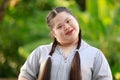 Portrait shot of Asian young chubby down syndrome autistic autism little cute schoolgirl with braid pigtail hairstyle model stand Royalty Free Stock Photo