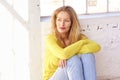 Portrait shot of attractive middle aged woman sitting on the floor while relaxing at home Royalty Free Stock Photo