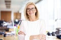 Portrait shot of attractive senior businesswoman standing in the office with arms crossed Royalty Free Stock Photo