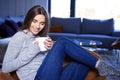 Young woman relaxing at home and having a cup of tea Royalty Free Stock Photo