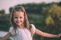 Portrait shot of cute little girl smiling in the meadow