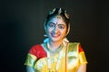 Portrait shot happy smiling Indian Bharatnatyam dancer on stage looking at camera - concept of classical dance