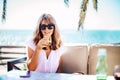 Happy woman enjoying sunny day while relaxing outdoor sofa Royalty Free Stock Photo