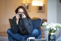 Relaxed young woman with beautiful smile sitting on the chair in the living room Royalty Free Stock Photo