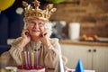 Portrait shot of lovely joyful senior woman wearing inflatable crown and smiling, feeling happy, celebrating her birthday Royalty Free Stock Photo