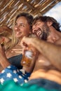 Portrait shot of lovely young couple sunbathing and hugging on beach. Enjoying summer holiday. Love, togetherness, holiday, Royalty Free Stock Photo